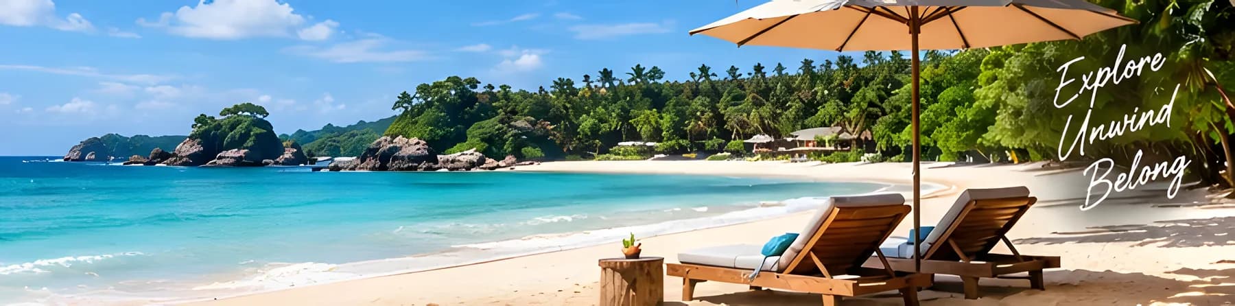 Sun loungers under a parasol on a turquoise bay