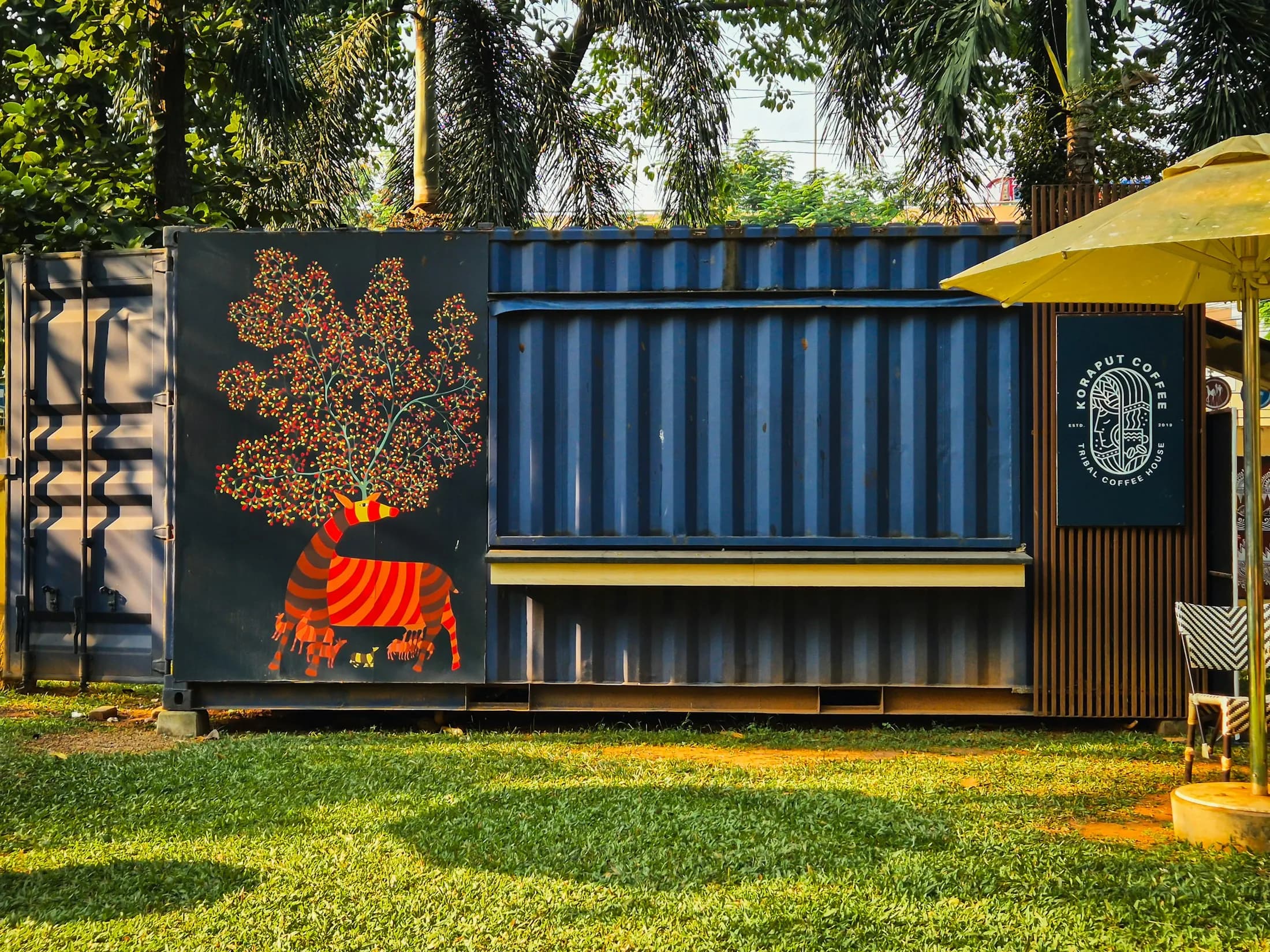 A shipping container converted into a kiosk in a park